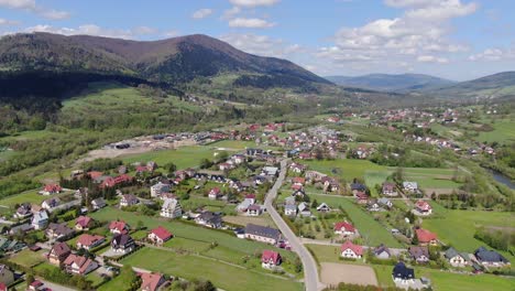 Aerial-panorama-of-Mszana-Dolna-village,-Poland-on-sunny-summer-day
