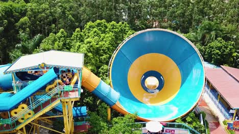 Kids-and-adults-queuing-up-and-riding-a-super-big-air-pillow-water-slide-at-the-Chimelong-Water-Park-in-Guangzhou,-China