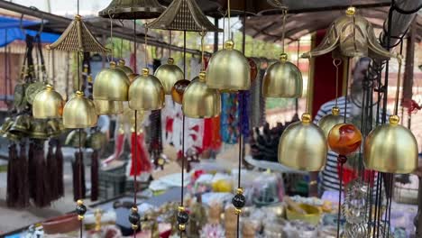 Brass-metal-art,-wind-chimes-made-with-brass-with-plain-blurred-background