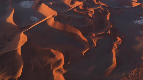 Aerial-overview-of-the-Namib-desert,-dramatic-sunset-in-Namibia---tilt,-drone-shot