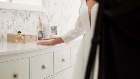 Photographer-Taking-Photos-For-Bride-Wearing-Wedding-Dress-Posing-In-Bedroom-In-Front-Of-Mirror