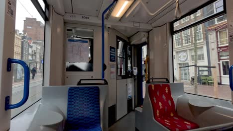 Inside-View-of-a-tramcar-traveling-into-the-city-of-Amsterdam-as-the-carriage-jolts,-Netherlands
