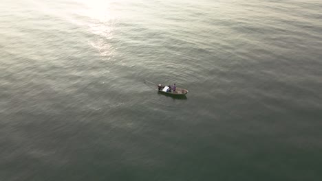 Aerial-Drone-Shot-of-Fisherman-Fishing-in-Open-Water,-Thailand