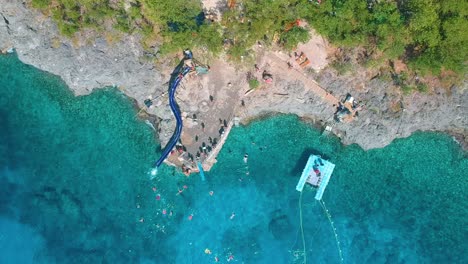 Aerial-View-Of-Tourists-Enjoying-Water-Slide-At-Eco-Parque-West-View-In-San-Andres-Island,-Colombia