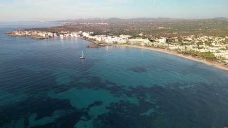 Sailboat-Floating-On-Clear-Blue-Sea-Off-The-Coast-Of-Sa-Coma-In-Mallorca,-Spain