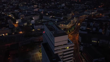 Aerial-night-Cityscape-of-Kaiserslautern-:-Municipality-building-and-shopping-mall-in-west-Germany-known-for-the-U