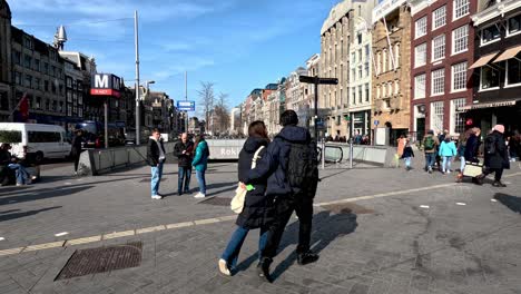 4-April-2023---People-And-Tourists-Walking-Past-Street-Entrance-To-Rokin-Metro-Station-In-Amsterdam