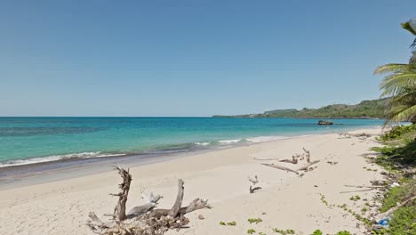 Drone-flying-low-over-Playa-Rincon-beach-in-Samana-peninsula,-Dominican-Republic