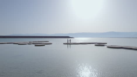couple-of-lovers-standing-on-the-big-salt-circles-on-the-Dead-Sea