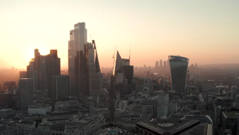 Aerial-slider-shot-City-of-London-skyscrapers-at-dawn-to-the-Thames-revealing-Canary-Wharf
