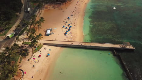 Luftaufnahme-über-Waikiki-Beach,-Schwenk-Nach-Oben,-Um-Honolulu-Und-Den-Diamond-Head-Krater-Im-Hintergrund-Zu-Zeigen