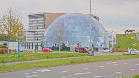 Wide-view-of-the-beautiful-AFAS-theater-in-Leusden-with-traffic-driving-in-front-of-the-building