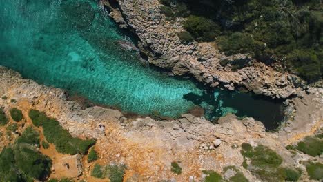 Remote-natural-bay-with-clear-turquoise-blue-sea-water-and-white-sand-beach,-Palma-de-Mallorca-Island