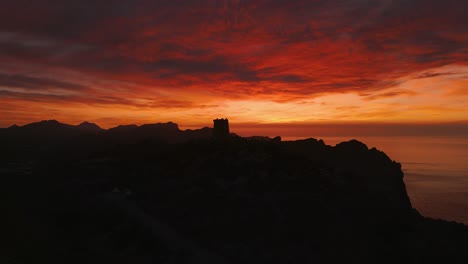 Red-sunset-at-Es-Colomer-Island-Albercutx-watchtower,-Cap-Formentor,-Mallorca,-Spain