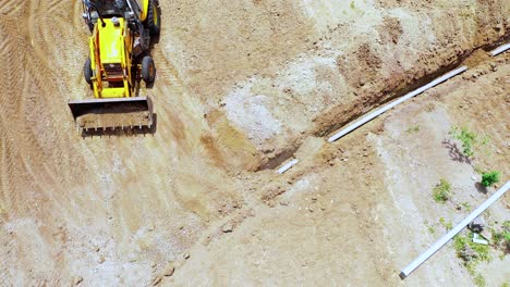 Aerial-shot-of-crawler-excavator,-Earthmoving-machine-at-construction-site-at-India