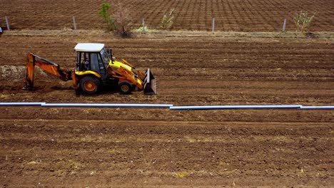 aerial-top-down-shot-of-water-pipeline-to-roll-in-the-agricultural-land