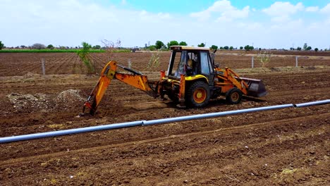 Aerial-drone-shot-of-excavation-straitening-full-starch-and-moving-forward-for-water-pipeline-solution-at-agricultural-land