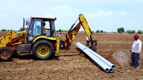 Excavation-machine-holding-Water-pipeline-and-putting-on-the-ground-for-the-fitting-of-water-solution
