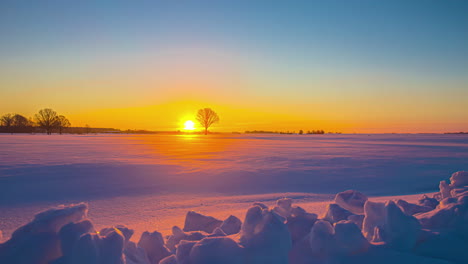 Beautiful-orange-and-purple-sunrise-over-a-landscape-covered-in-snow