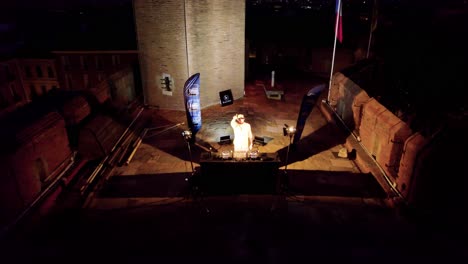 Drone-View-of-DJ-Bidding-Farewell-to-His-Audience-on-the-Rooftop-of-Castillet-in-Perpignan-Amidst-Starry-Night
