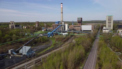 Old-coal-mine-elevator-and-piles-of-slag-behind-in-Karvina-on-a-sunny-day
