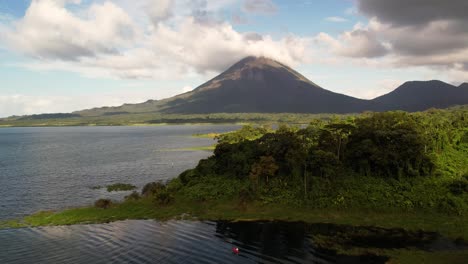 Drone-ascent-revealing-scenic-Arenal-Volcano-tropical-surroundings