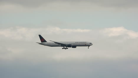 plane-flying-in-the-sky,-descending-to-arrival-flies-through-clouds,-it's-an-air-canada-airlines-aircraft