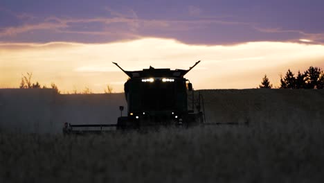 Harvester-at-night-in-the-field-harvests-wheat,-rare-footage,-reminiscent-of-the-steel-hand-of-the-Lord