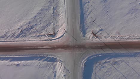 Aerial-top-view-of-a-snow-covered-intersection-in-the-countryside-of-Canada