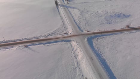 Aerial-view-of-a-junction-in-the-countryside-of-Canada-covered-by-snow-after-a-heavy-blizzard