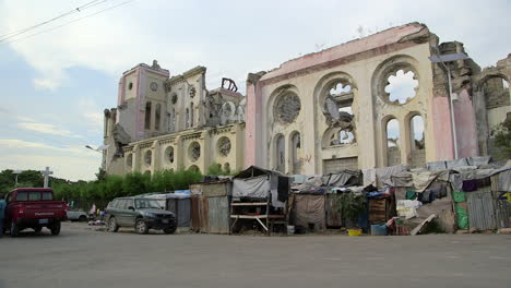 Slums-near-Cathedral-of-Port-au-Prince,-man-walks-by