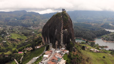 Establishing-tilt-up-aerial-view-of-an-epic-tourist-destination-Piedra-del-Penol
