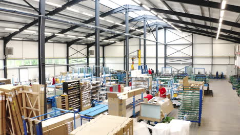 Logistics-workers-preparing-shipping-packets-in-factory-warehouse