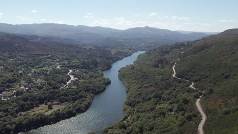 Calm-river-flowing-through-a-valley-leading-to-a-mountain-in-Peneda-National-Park,-Portugal