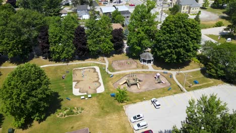 Aerial-shot-circling-over-a-park-and-playground-on-a-sunny-day-in-Mount-Brydges
