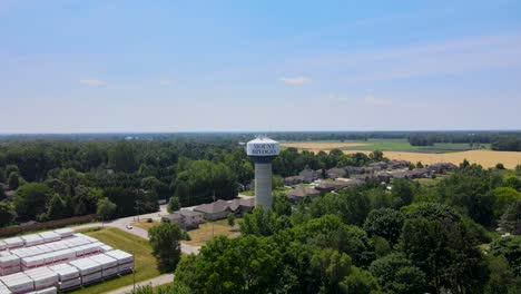 Drone-flying-towards-the-Mount-Brydges-water-tower-near-London,-Ontario