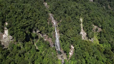 Birds-eye-view-of-waterfall,-wild-scenery-of-West-Coast,-South-Island,-New-Zealand