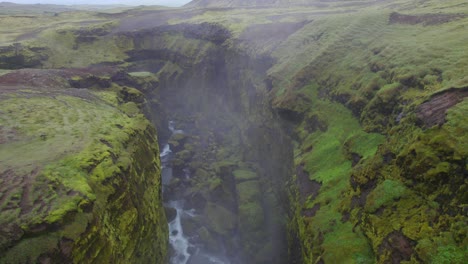 Antena-Sobre-El-Terreno-Accidentado-Cerca-Del-Famoso-Monumento-Natural-Y-Atracción-Turística-De-Las-Cataratas-Skogafoss-Y-El-Sendero-Fimmvorduhals-En-Islandia