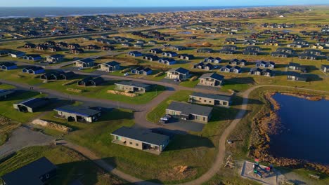 Drone-shot-houses-and-huts-in-countryside-coastal-town-in-Denmark