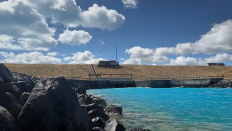 Starting-point-of-Pukaki-hydro-canal-viewed-from-its-shore-in-sunshine