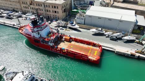 Drone-aerial-shot-orbiting-around-a-Tug-Boat-in-a-ship-yard