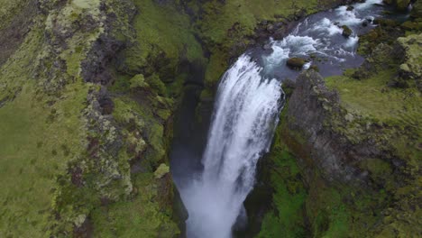 Aerial-high-above-the-famous-natural-landmark-and-tourist-attraction-of-Skogafoss-falls-and-Fimmvorduhals-trail-in-Iceland