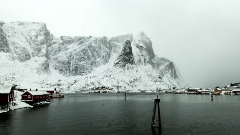 Fishing-village-in-arctic-Norway-surrounded-by-jagged-snowy-mountains
