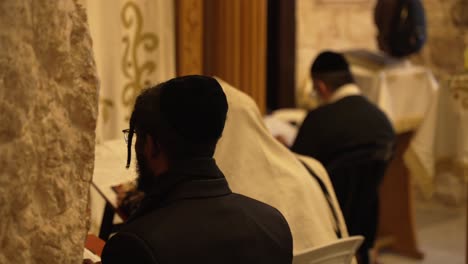 Jewish-men-reading-and-praying-from-a-Torah-scroll
