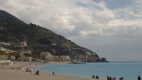 Relaxing-Maiori-coastline-beach-with-tourists-and-beachgoers,-Italy