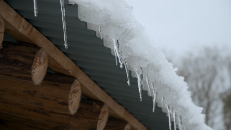 Water-Dripping-From-Icicles-Hanging-On-The-Roof-Of-House