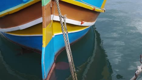 Close-up-of-colorful-picturesque-wooden-boat-moored-in-port-of-Malta