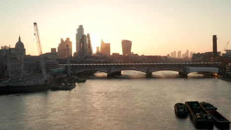 Aerial-shot-over-the-river-Thames-looking-towards-London-skyscrapers