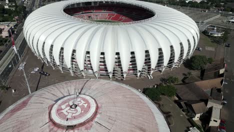 Approaching-Estádio-Beira-Rio-modern-oval-soccer-field-stadium-aerial-view,-Porto-Alegre,-Brazil
