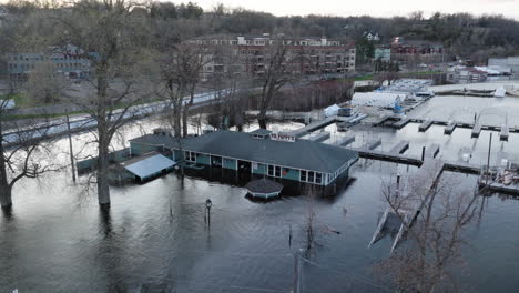 Flooded-marina-restaurant-half-submerged-underwater-along-St